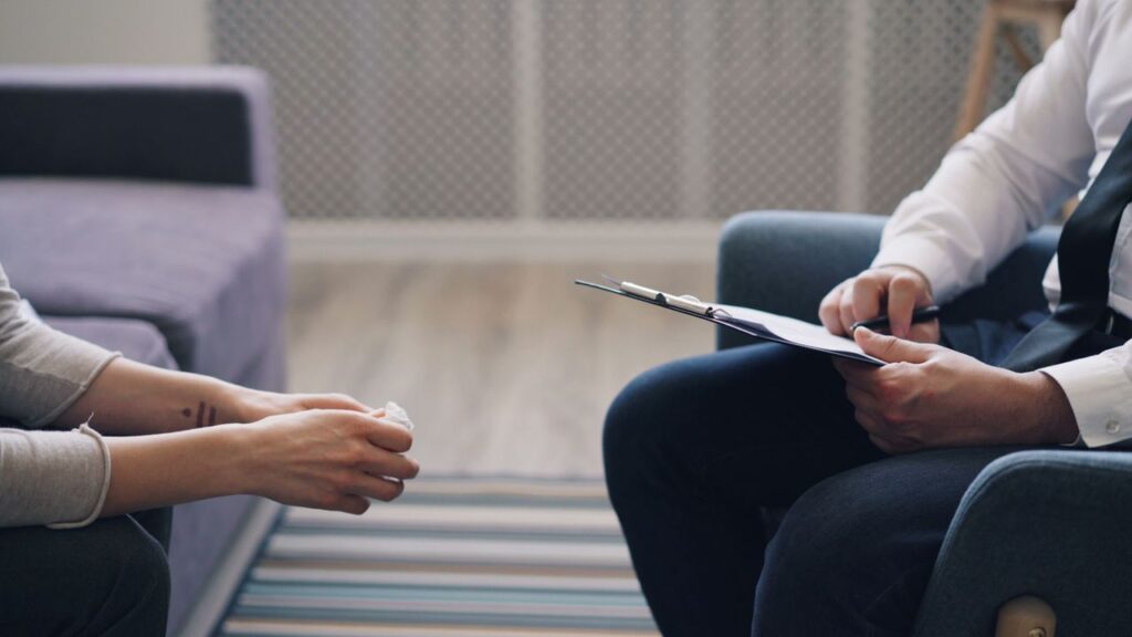 pexels photo 23496452 A therapy session with a psychologist and patient, discussing mental health indoors.