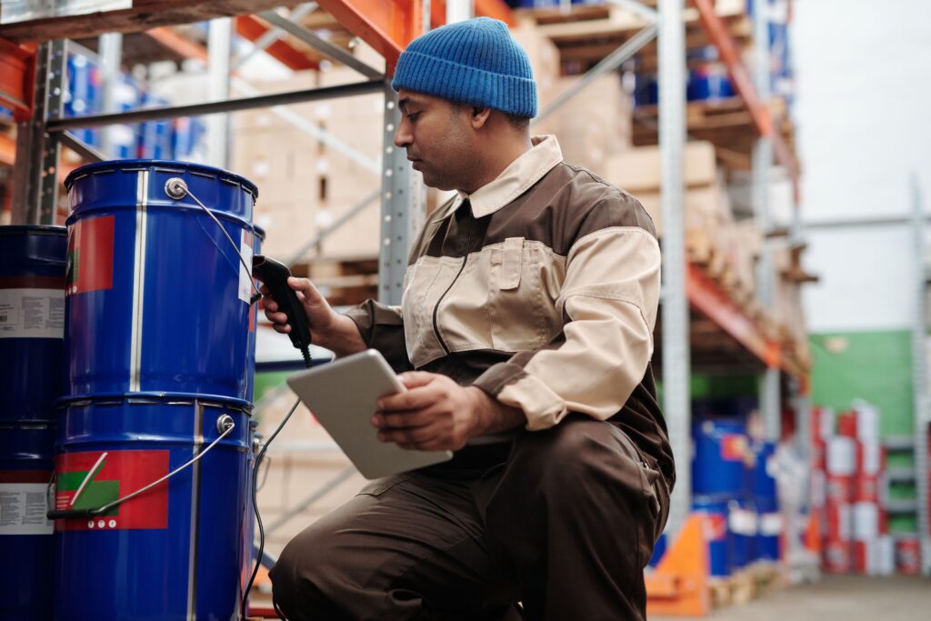 pexels photo 4484154 4484154 Warehouse employee scanning inventory using tablet and scanner in industrial storage area.